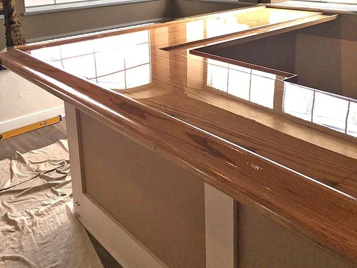 an unfinished counter top in front of a window