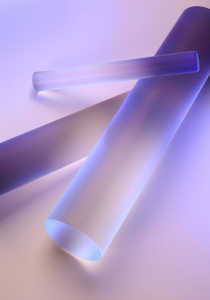 two blue tubes on a white surface with some blurry light coming from the top