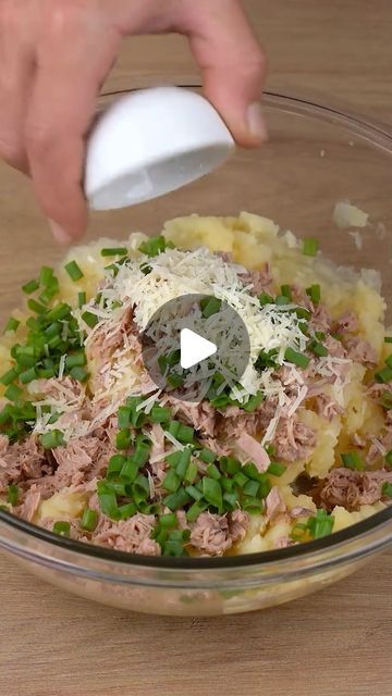 someone is mixing food in a bowl on the table with a plastic spatula to mix it together