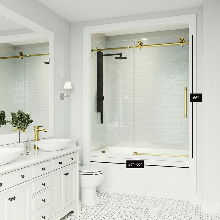 a white bathroom with two sinks and a bathtub