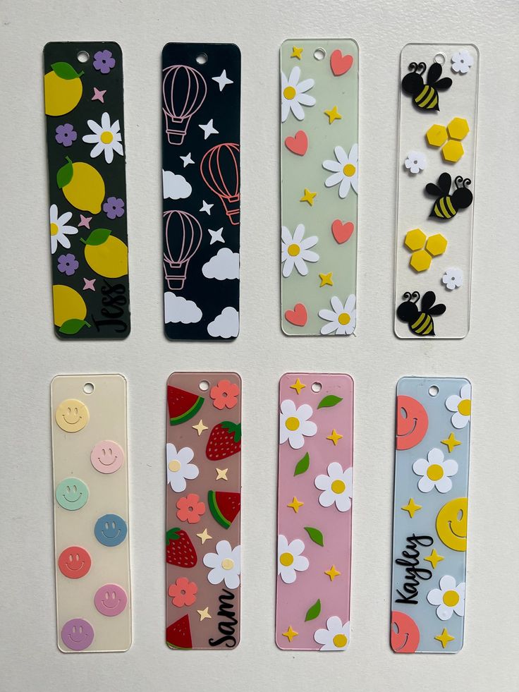 four cell phones with different designs on them and buttons attached to the back of them