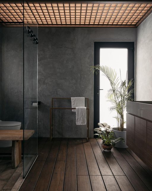 a bathroom with a wooden floor and walls