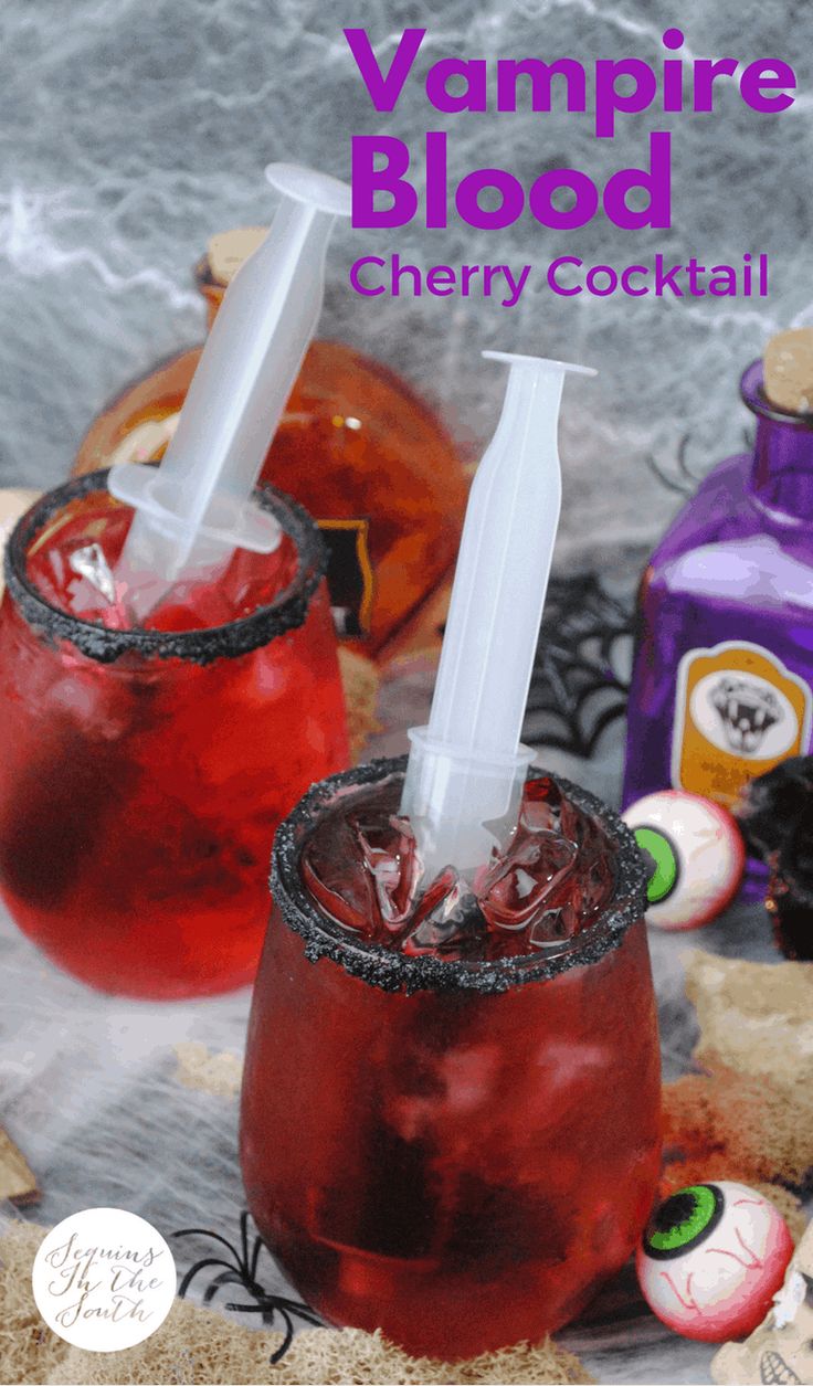 two glasses filled with vampire blood drink next to halloween decorations