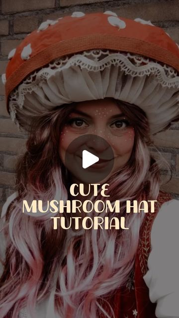 a woman with pink hair wearing a mushroom hat