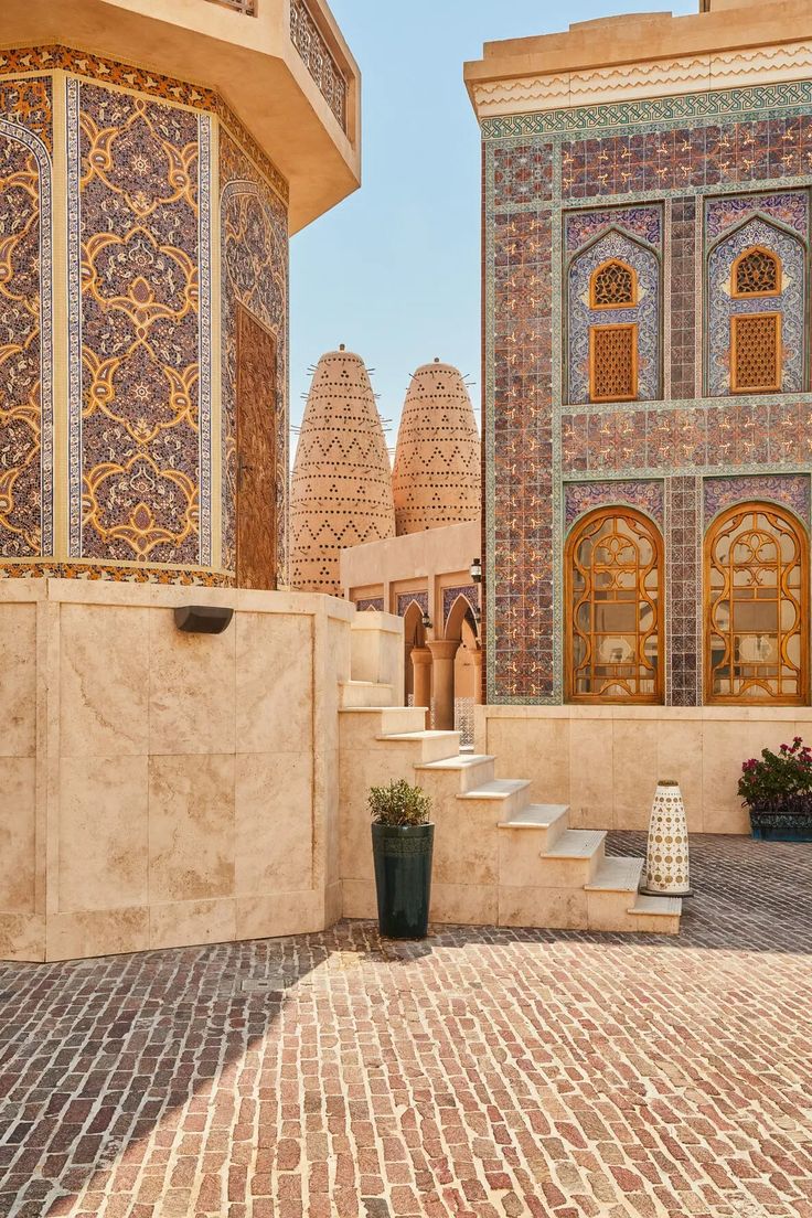 an outdoor courtyard with steps and tiled walls