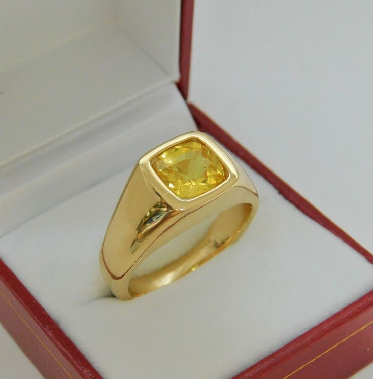 Gemstone: Yellow sapphire A gem certificate of authenticity will be provided at no charge. Treatments: Heated/Lattice Diffusion Specifications: 8.03x8.1mm, approx. 2.89 carats Color: As shown Stunning rare lemon yellow Clarity: Eye clean, almost loupe clean Cut: Cushion cut Weight: 16 grams. Ring size: 10, with all sizes available from 6.5 through 12 This is as fine and elegant a man's ring as you will ever find. The perfect blend of a fine gemstone matched up with a clean classic 14K yellow gol Luxury Yellow Gold Men's Ring With Bezel Setting, Yellow Stone Ring Men, Yellow Sapphire Ring Men, Safire Rings, Indian Wedding Suits Men, Mans Ring, Yellow Stone Rings, Gold Jewelry Outfits, Yellow Sapphire Rings