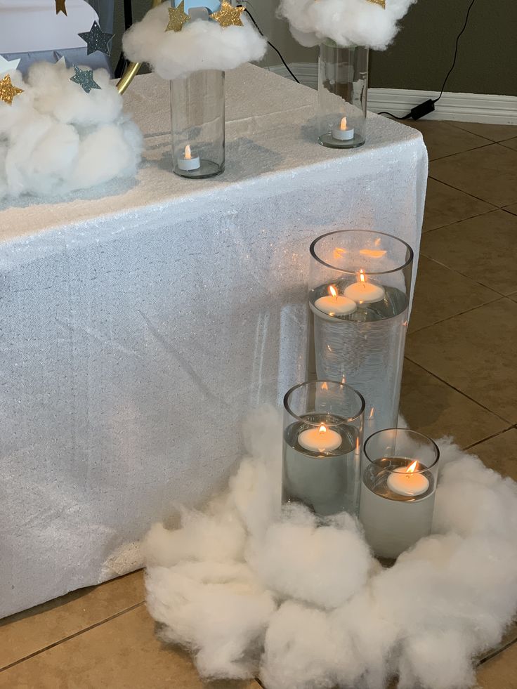 clouds and candles on a table with white linen