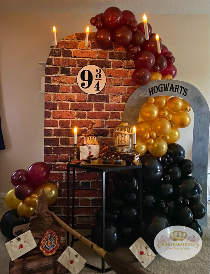 a birthday party with balloons and candles on the fireplace mantel, along with a harry potter sign