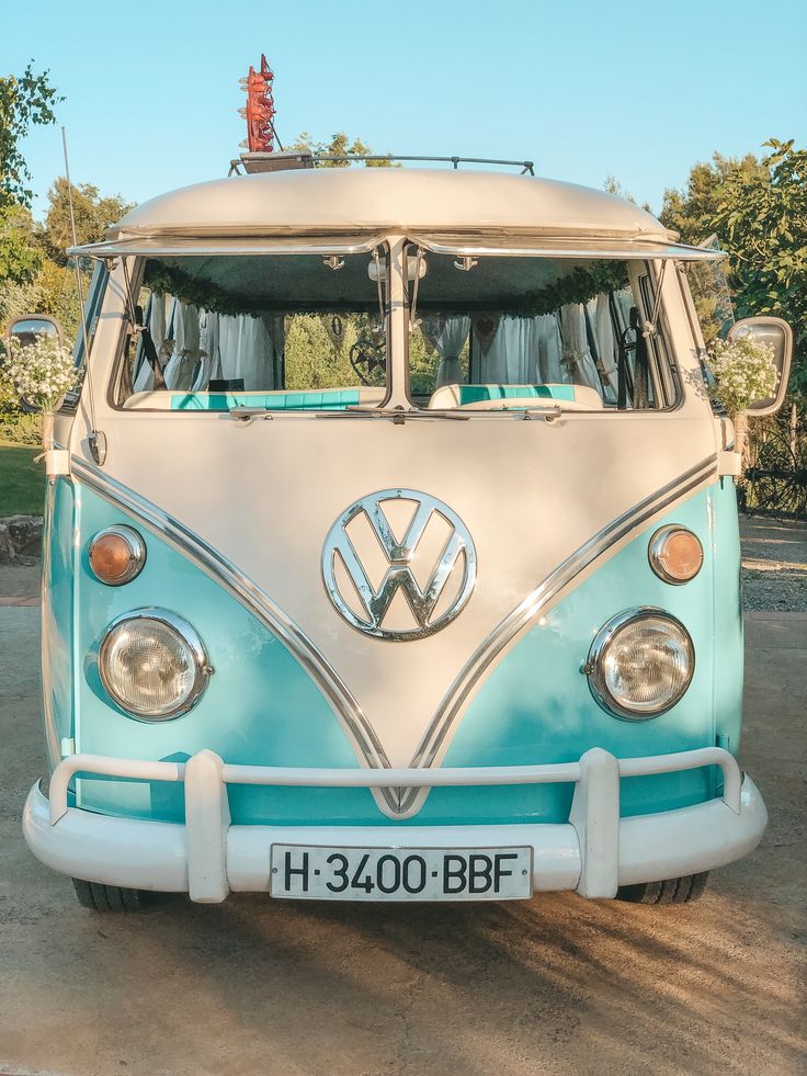 an old vw bus is parked in a lot