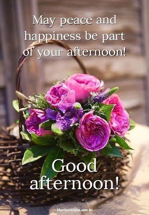 a basket filled with flowers sitting on top of a table next to a sign that says, may peace and happiness be part of your afternoon