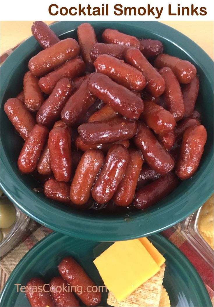 two bowls filled with hotdogs and cheese on top of a table next to each other