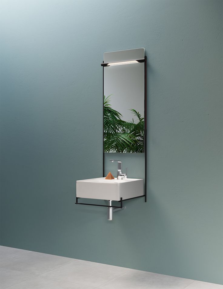 a bathroom sink sitting under a mirror next to a wall mounted shelf with a plant on it