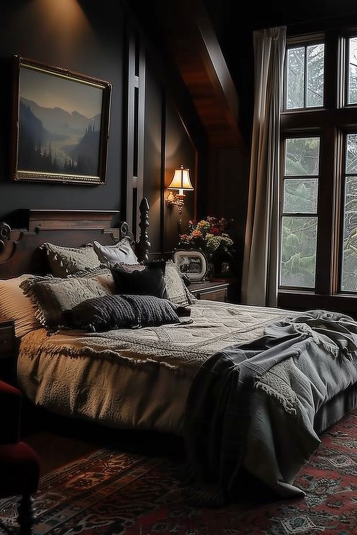 a large bed sitting in the middle of a bedroom next to two lamps and windows