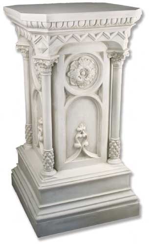 a white clock on top of a pedestal