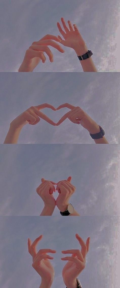 several hands making the shape of a heart with their fingers in front of blue sky