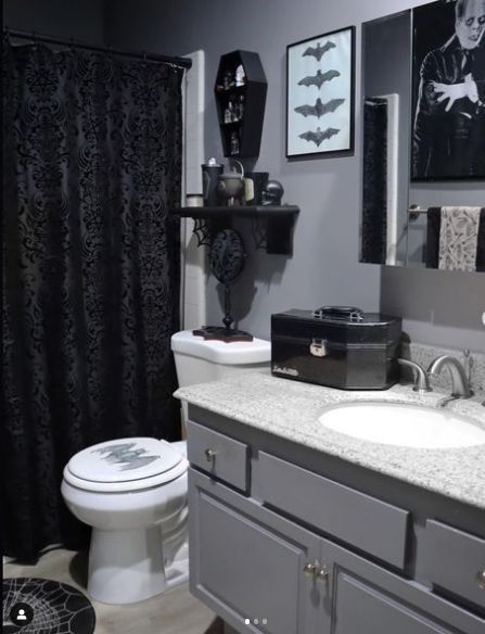 a bathroom with black and white decor on the walls