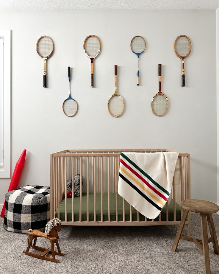 a baby's room with lots of clocks on the wall and a crib