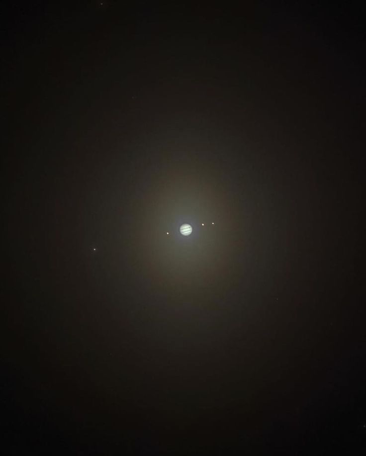 the sun and two planets are seen in the dark sky