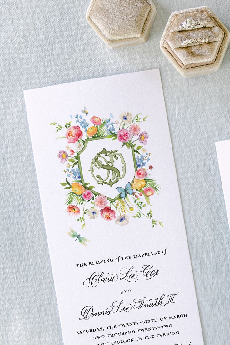 the wedding stationery is decorated with flowers and monogrammed initials