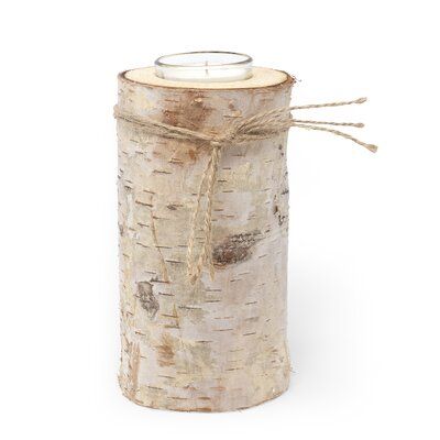 a candle is wrapped in twine and tied to a birch tree trunk with rope