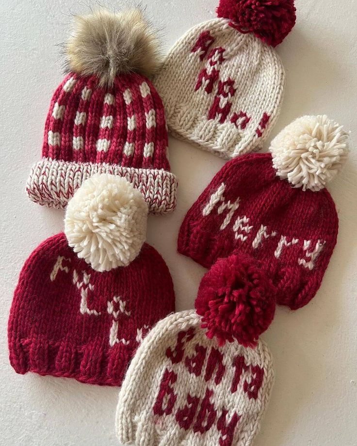 three knitted hats with pom poms on them