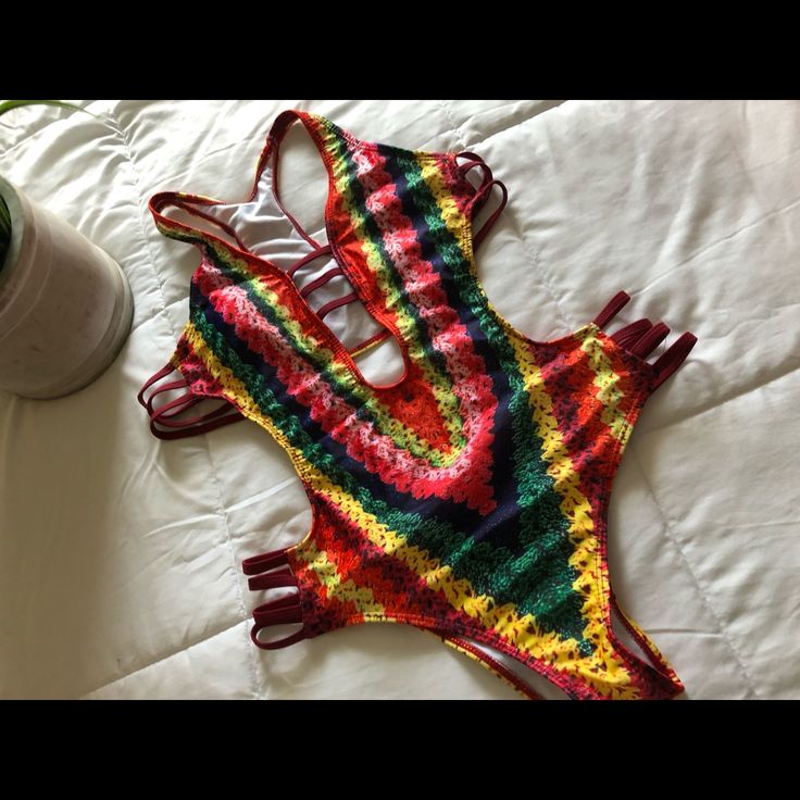 This Suit Is Uber Sexy Yet Fun At The Same Time. The Cut And The Straps On This Suit Make It Very Flattering. Size Large But I Feel Would Also Fit A Size Medium. Never Worn. Feel Free To Make An Offer! Rave Multicolor Bodysuit For Club, Rave Style Multicolor Bodysuit For Club, Multicolor Sleeveless Bodysuit For Festivals, Sleeveless Multicolor Bodysuit For Festivals, Multicolor Rave Swimwear For Vacation, Rave Style Multicolor Swimwear For Vacation, Rave Multicolor Swimwear For Vacation, Multicolor Backless Bodysuit For Beach Season, Multicolor Backless Bodysuit For Vacation