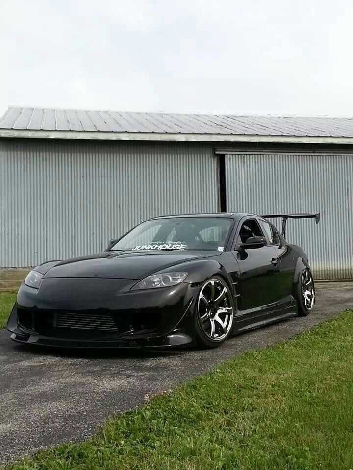 a black sports car parked in front of a building