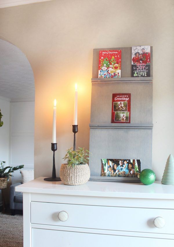 a white dresser with two candles on it