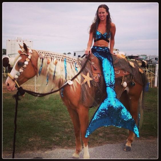 a woman is sitting on top of a horse wearing a mermaid tail and blue sequins