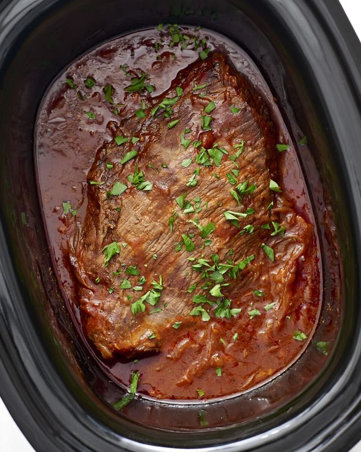 the meat is covered in sauce and garnished with parsley