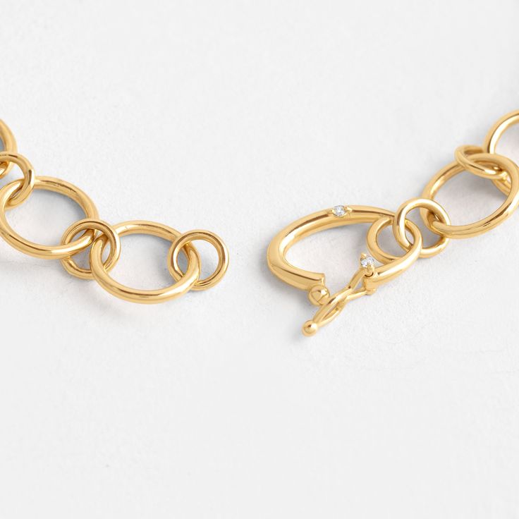 14k gold hand-fabricated link chain with rings alternating from 2mm to 6mm Custom catch clasp set with three 1mm white diamonds (SI clarity) We handcraft each piece with responsibly sourced 14k gold and ethically sourced stones. 7” in total length Everyday Diamond Link Jewelry, Timeless Link Chain Bracelet With Lobster Clasp, Fine Jewelry Oval Link Chain Bracelet For Everyday, Gold Diamond Link Bracelet With Adjustable Chain, Everyday Oval Link Diamond Jewelry, Elegant Metal Chain Bracelet With Hooks And Links, Timeless Gold Link Bracelet With Lobster Clasp, Modern Jewelry With Solid Link Construction For Anniversary, Minimalist Jewelry With Solid Link For Anniversary