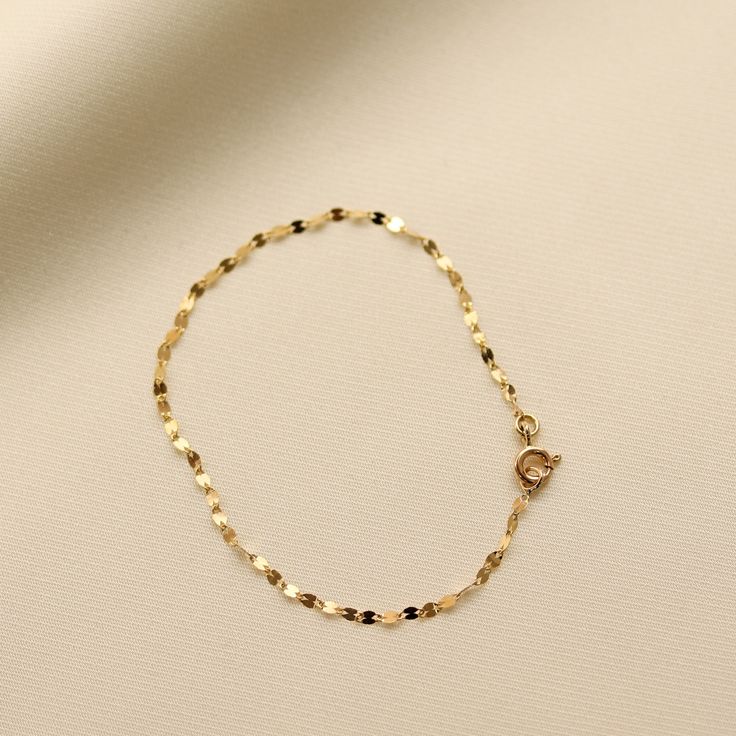 Add some sparkle to your wrist with our Glitter Chain Bracelet! Made with 14K Solid Gold, this delicate and dainty bracelet is the perfect accessory for any occasion. The glitter chain adds a touch of shine and whimsy to your outfit. Gold KT: 14K Solid Gold Gold Color: Yellow Gold Chain Lengths: 6.5", 7" Chain Widths: 2 mm Chain Style: Glitter Chain Clasp Closure: Spring Ring Dainty 14k Gold Filled Adjustable Chain Bracelet, Rose Gold Delicate Chain Bracelet For Party, Party Rose Gold Bracelets With Delicate Chain, Gold Charm Bracelet With Lobster Clasp For Party, 14k Gold Bracelets With Adjustable Chain For Party, Adjustable Dainty Chain Bracelet For Parties, Minimalist Chain Bracelets For Party, Gold Plated Chain Bracelet For Party, Elegant Gold Bracelet With Adjustable Chain For Parties