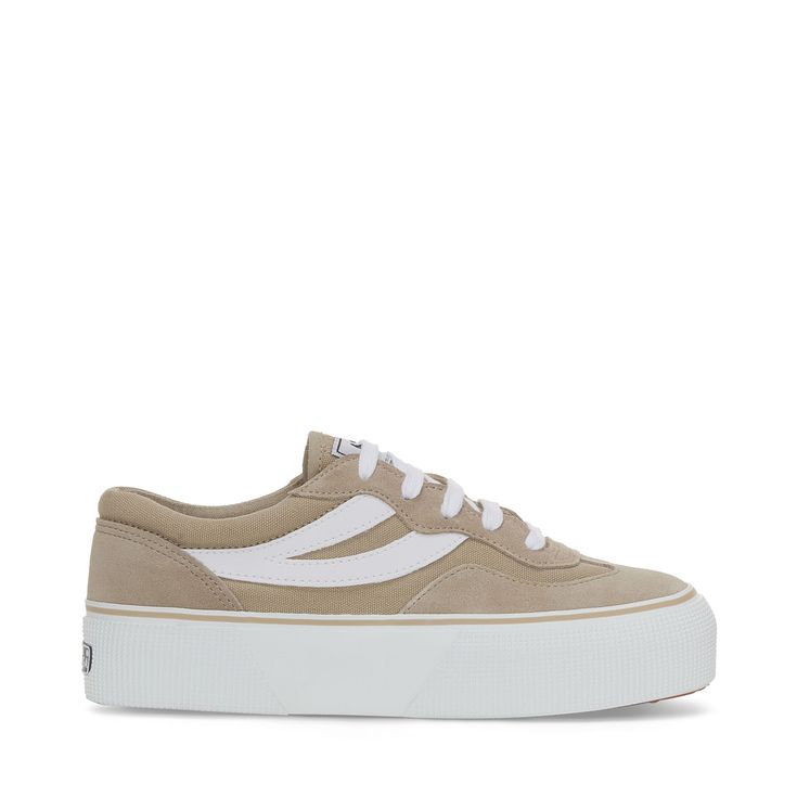 Sporty influences, 90s volley references, and iconic details capture Superga's dynamic side. The Revolley sneaker is a fusion of effortless style and lightweight comfort, crafted from luxurious suede and breathable cotton. Leather swallowtail detailing and a stripe along the foxing complete the look with a graphic touch. 
Low-top design
Suede upper
Breathable cotton canvas detailing
Nylon micro-mesh lining
1.5 in foxing with contrast stripe
Jacquard logo tag on the tongue
Printed logo on the back and insole
Logo-engraved aluminum eyelets
Leather swallowtail detail
Cotton laces
Vulcanized natural rubber sole Striped Wedding, Toddler Sneakers, Baby Sneakers, Logo Tag, Sneakers Grey, Classic Sneakers, Top Design, Canvas Sneakers, Platform Sneakers