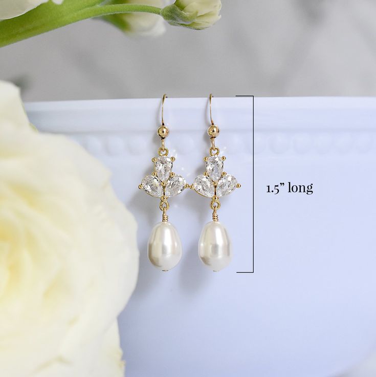 Dainty yet glamorous, The Rose Earrings in Gold, are the perfect accessory to accent a bateau neckline for both you and your bridesmaids. The subtle sparkle adds a touch of elegance to your wedding day look. Size: 1.5" long Materials: cubic zirconia, Swarovski pearls in white Metals: gold filled ear wires and components Find the matching necklace here Elegant Hypoallergenic Crystal Earrings For Formal Occasions, Classic Teardrop Bridal Earrings For Mother Of The Bride, Elegant Formal Bridal Accessories With Pearl Drop, Classic Crystal Earrings For Wedding With Elegant Design, Classic Elegant Crystal Earrings For Wedding, Elegant Sparkling Pearl Earrings For Wedding, Formal Bridal Earrings Cubic Zirconia Hypoallergenic, Elegant Crystal Earrings For Wedding, Delicate Cubic Zirconia Bridal Earrings For Formal Occasions