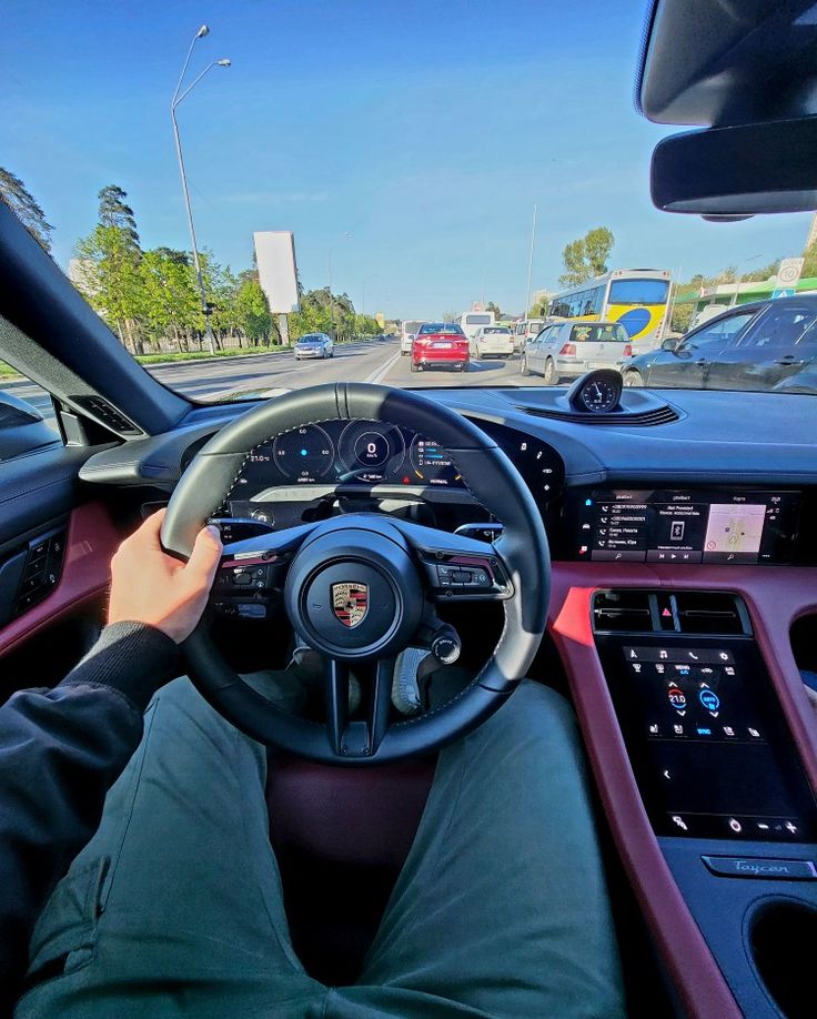 a man driving a car down a street