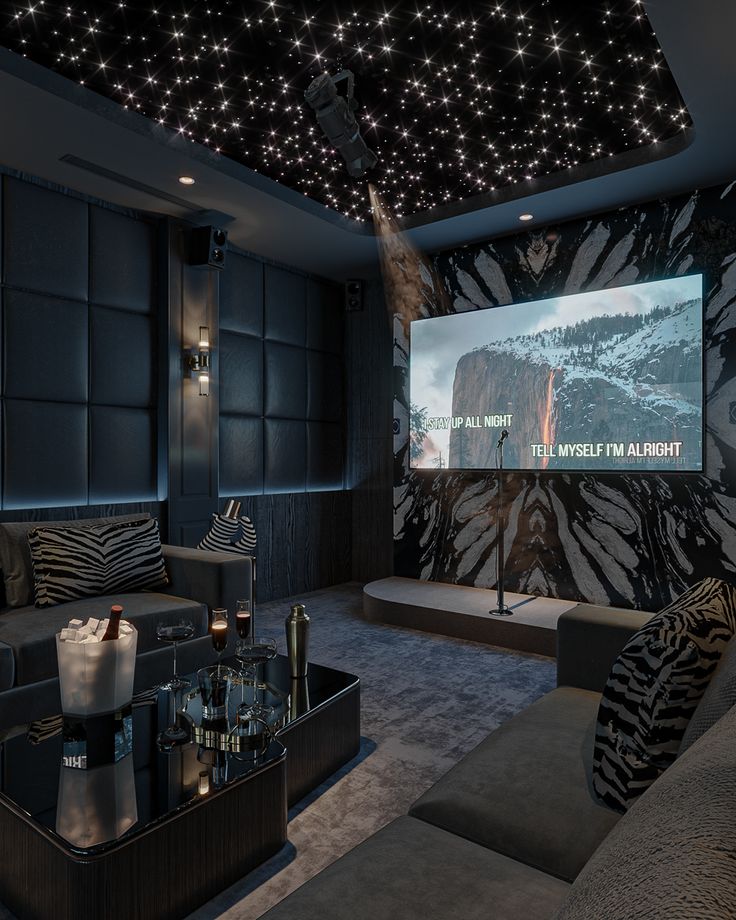 a home theater with zebra print wallpaper and black leather couches in front of a large projector screen