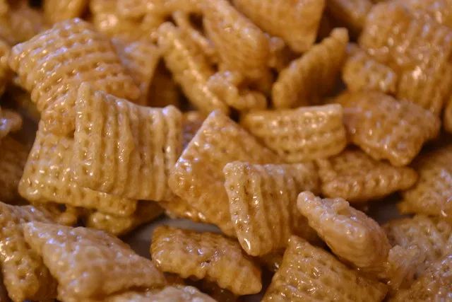 a close up view of some kind of cereal that looks like cheetos with peanut butter on top