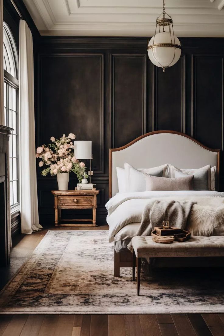 a bedroom with black walls and white bedding in the center, along with a large rug on the floor