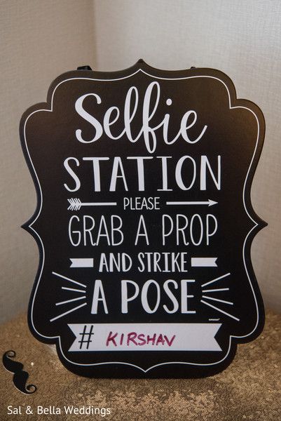 a black and white sign that says selfie station please grab a prop and strike a pose