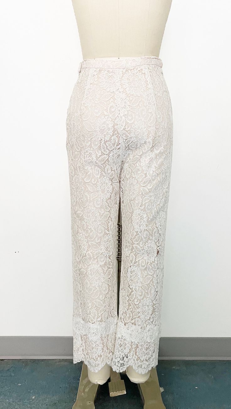 Mod 1960s handmade lace pant set - Skinny strap white lace tunic with sweetheart neckline and scalloped hem. Metal zipper on the back with hook-and-eye closure at top. Fully lined with blush fabric and nude overlay. - Cropped straight leg high-rise white lace pants with scalloped hem. Side metal zipper and hook-and-eye closure on tab. Fully lined in blush fabric with nude overlay. Label: Fashioned by Ruth Steele Chic Fitted Bottoms With Delicate Lace, Spring Fitted Bottoms With Scalloped Lace, Feminine Lace Party Bottoms, Elegant Scalloped Lace Bottoms For Spring, Fitted Party Bottoms With Delicate Lace, Fitted Bottoms With Scalloped Edges For Spring, Chic Beige Bottoms For Wedding, Fitted Bottoms With Scalloped Lace For Party, Fitted Scalloped Lace Party Bottoms