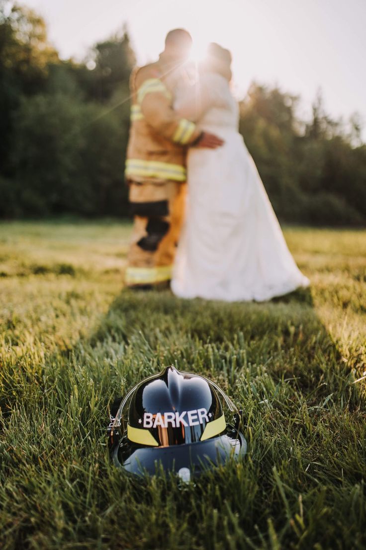 a helmet sitting in the grass next to a fireman