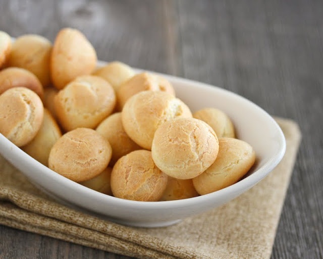 a white bowl filled with cookies on top of a wooden table