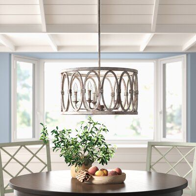 a dining room table with chairs and a potted plant