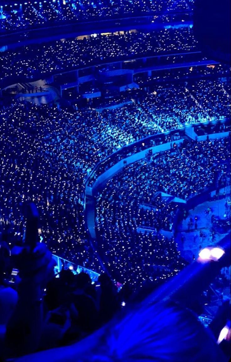 an arena filled with lots of people at night