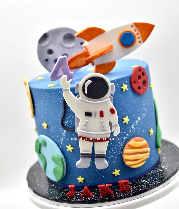 a birthday cake with an astronaut on top