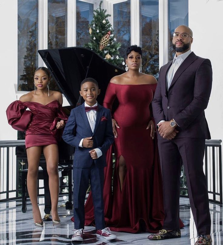 a family posing for a photo in front of a christmas tree with the caption tasiaword