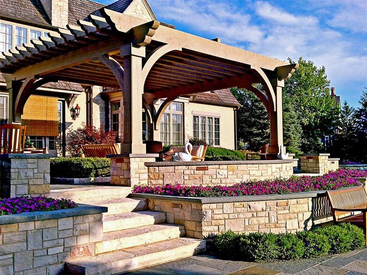 an outdoor patio with stone steps and seating area