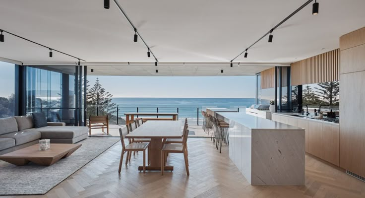 an open living room and dining area overlooking the ocean