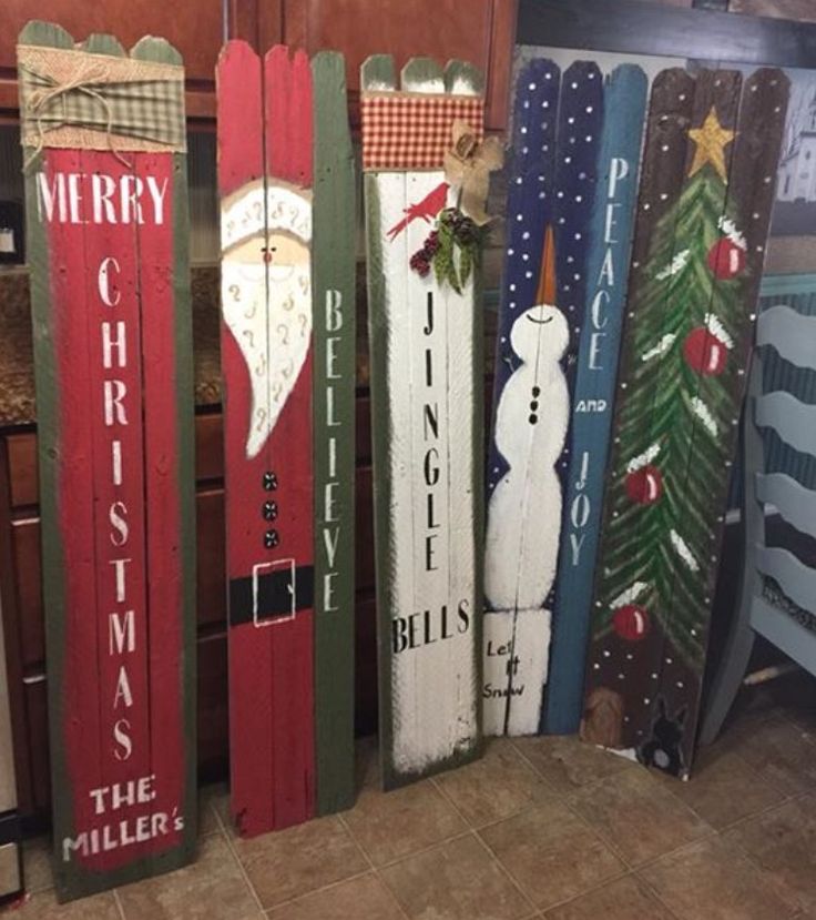 wooden christmas signs are lined up on the floor