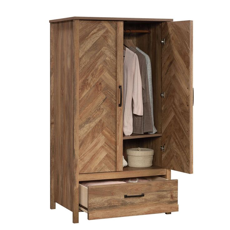 a wooden armoire with two drawers and a coat hanging on the door, in front of a white background